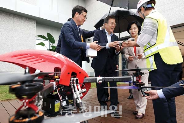 문재인 대통령이 17일 서울 마곡 R&D 단지에서 열린 혁신성장 점검회의에 앞서 사전환담 중 드론이 운반한 커피음료를 받고 있다.