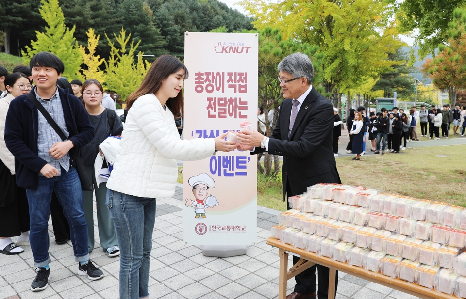 한국교통대 박준훈(오른쪽) 총장이 23일 충주캠퍼스 재학생에게 간식을 나눠주고 있다.