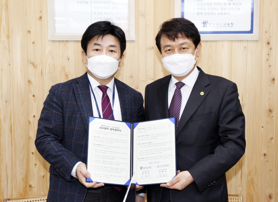 김해수(왼쪽) 스마트경영포럼 회장과 김병우 충북도교육감이 21일 업무협약을 체결하고 기념촬영을 하고 있다.